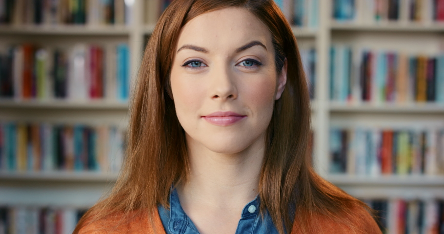Portrait, face and books with a woman at work in a bookstore, library or research center with a smile. Student, school or college with a female employee working in an ireland university for education | Shutterstock HD Video #1097501295
