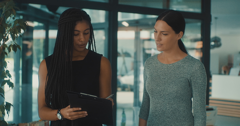 Young business people in discussion, mixed woman race. Creative team meeting in modern work space. We are stronger together. Female chef. An empowered workplace. 4k slow motion video. | Shutterstock HD Video #1097501671