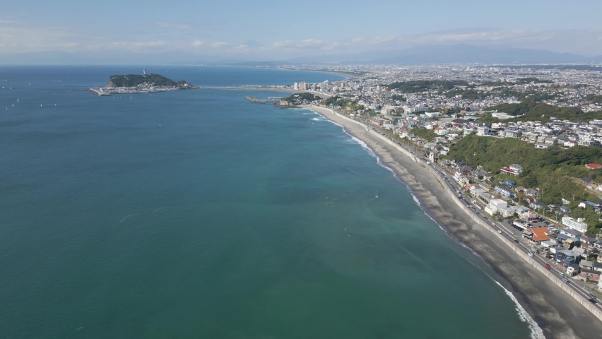 Aerial drone view of Enoshima island and blue sea on a sunny day, Japan Royalty-Free Stock Footage #1097503777