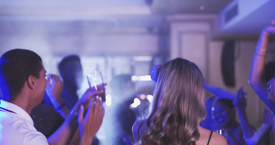 Dance, nightclub and party with woman friends at an event, cocktail bar or disco for a new year celebration together. Birthday, event and fun with a young female and friend dancing inside a venue | Shutterstock HD Video #1097503797