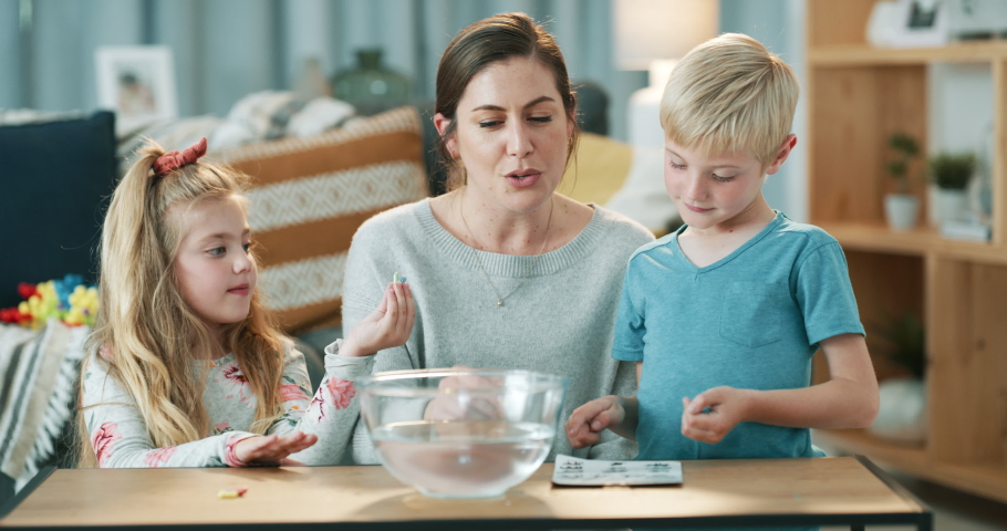 Mother, children or science experiment in house or home living room for education, learning or lockdown study. Smile, happy or talking mom and kids bonding and water bowl research for school homework | Shutterstock HD Video #1097503867