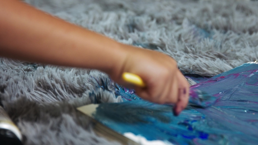 Children draw sitting on the floor, carpet and draw children close-up, fluffy carpet close-up and paint | Shutterstock HD Video #1097504747