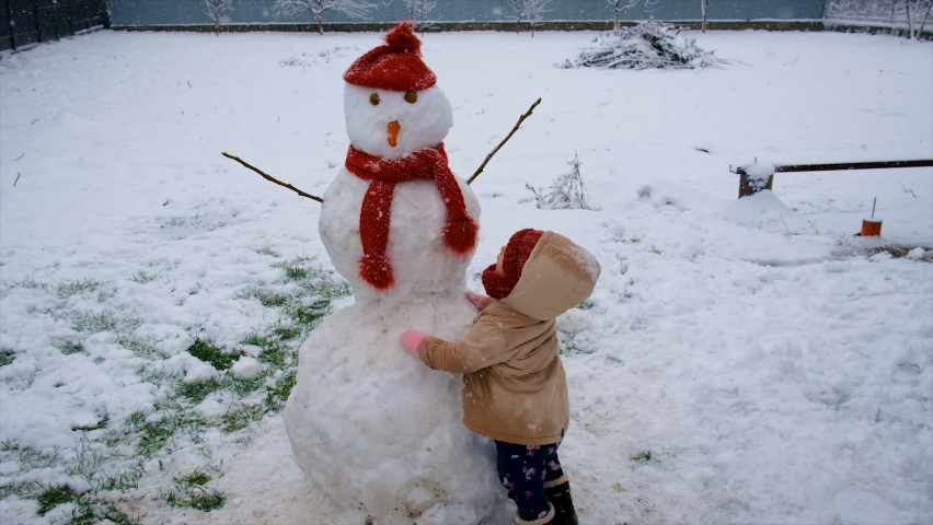 Children make a snowman out of snow. selective focus. | Shutterstock HD Video #1097510659