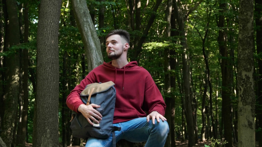 Unity with nature. Man spending time in forest, camera moving left