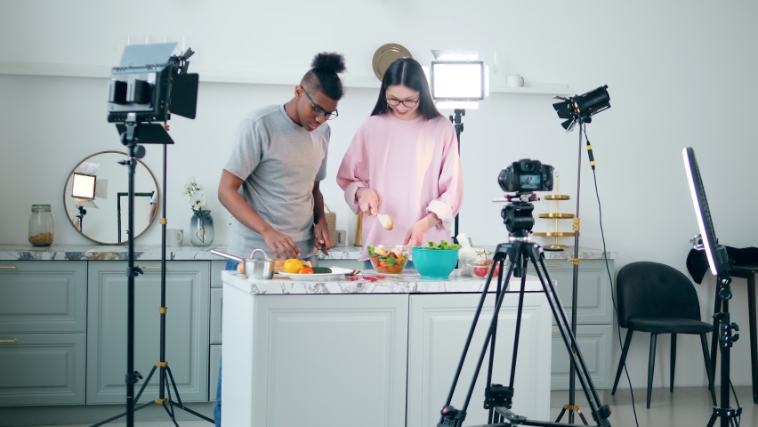 Video shoot of a couple of blogers cooking in the studio | Shutterstock HD Video #1097516253