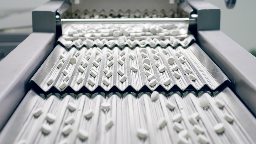 Stepped conveyor with drugs getting transported by it