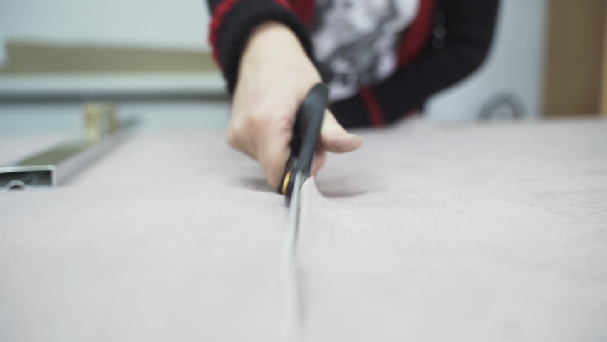 The cutter cuts the fabric with scissors along the line. Close-up. | Shutterstock HD Video #1097516981