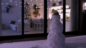 modern aparment decorated to Christmas holidays with snowman and fluffy snow on patio - Powered by Shutterstock - Get 15% off with code: PIKWIZARD15