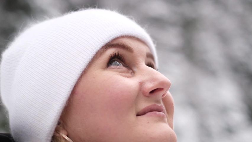 Portrait of a young woman in a white hat in the middle of a winter forest | Shutterstock HD Video #1097520383