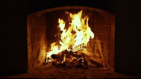 Fireplace Burning Wood Logs, Cozy Warm Home Christmas Time Burning Fire In The Fireplace. Slow Motion. A Looping Clip of a Hearth with Medium Size Flames