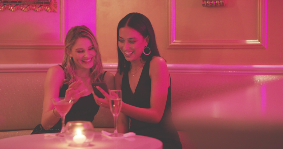 Party, friends and women with phone in nightclub typing message on social media, networking and online dating app. Celebration, social event and girls using smartphone at rave, disco and cocktail bar | Shutterstock HD Video #1097522161