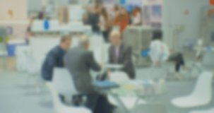 Modern business life.Blurred defocused video on business topic.Silhouettes of unrecognizable people who are holding a business meeting.