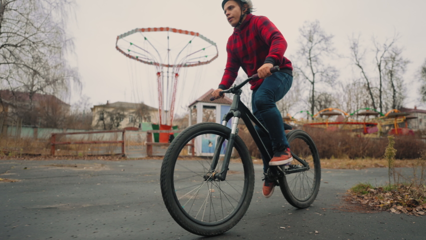 Adolescent is riding bmx bike and doing flips, rotation on 180 degrees, slow motion shot | Shutterstock HD Video #1097525249