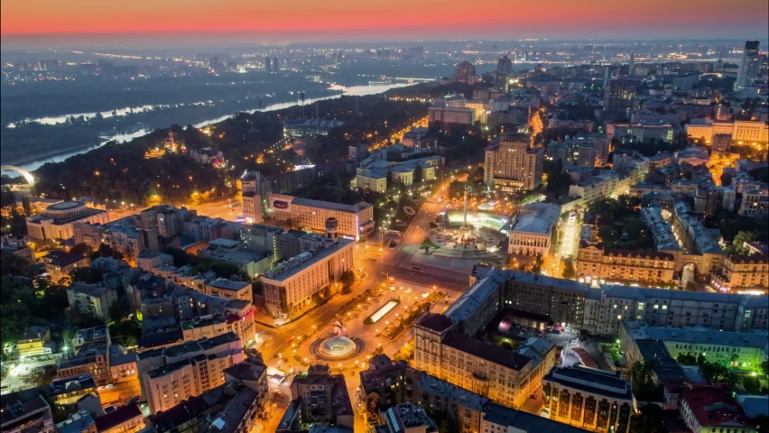 Morning aerial hyperlapse of Kyiv city center. Flying over Independence Square Maidan Nezalezhnosti in Kiev, Ukraine before sunrise. Red morning sky at background