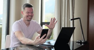 Happy man is using mobile phone for video call and showing thumb up