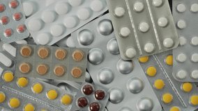 Pills, capsules and tablets with blister packs rotating close up. Concept of pharmacy, medical treatment, medicine, healthcare, vitamins, medications, pharmaceutical industry, pills. Rotating slow mo - Powered by Shutterstock - Get 15% off with code: PIKWIZARD15