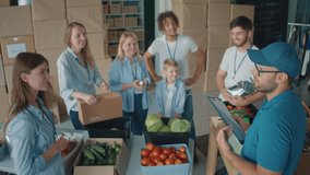 The Concept of Social Aid: A Group of Charity Workers and Community Members of All Ages Listening to Mentor at Volunteer Warehouse. Charity, Donation, and Volunteering Concept. - Powered by Shutterstock - Get 15% off with code: PIKWIZARD15