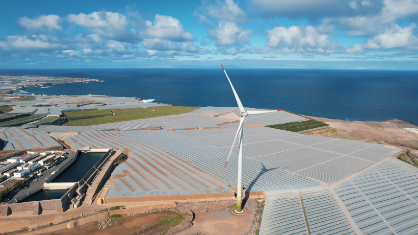 Aerial shot in orbit over a wind turbine and in the background the Atlantic Ocean on a sunny day. In the city of Galdar located on the island of Gran Canaria. Spain. | Shutterstock HD Video #1097550667