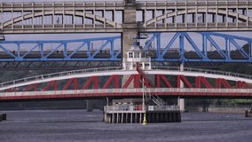 Long shot of Tyne bridges as high speed train crosses the river in Newcastle
