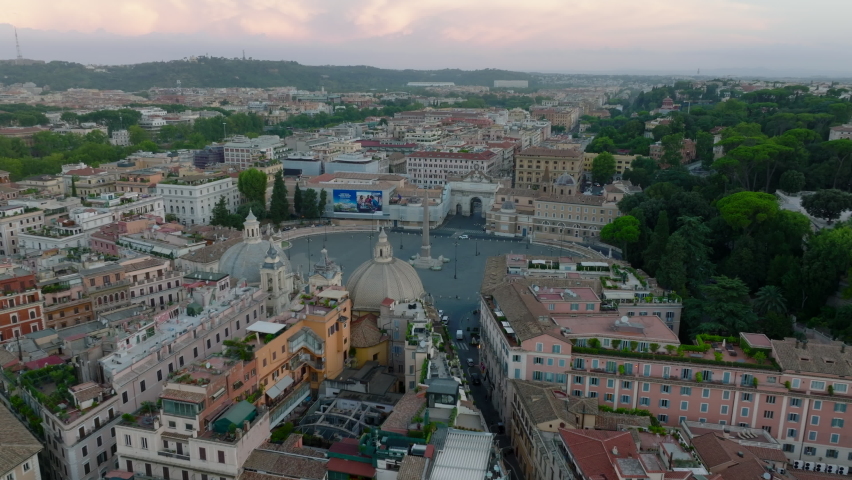 Tourist landmarks and old residential houses in historic city centre. Forwards fly above metropolis at twilight. Rome, Italy