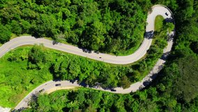 Aerial view over the mountain winding road, amazing road in the green tropical forest. Thailand, Southeast Asia. tourism and travel concept. Natural texture background. Drone 4K video
