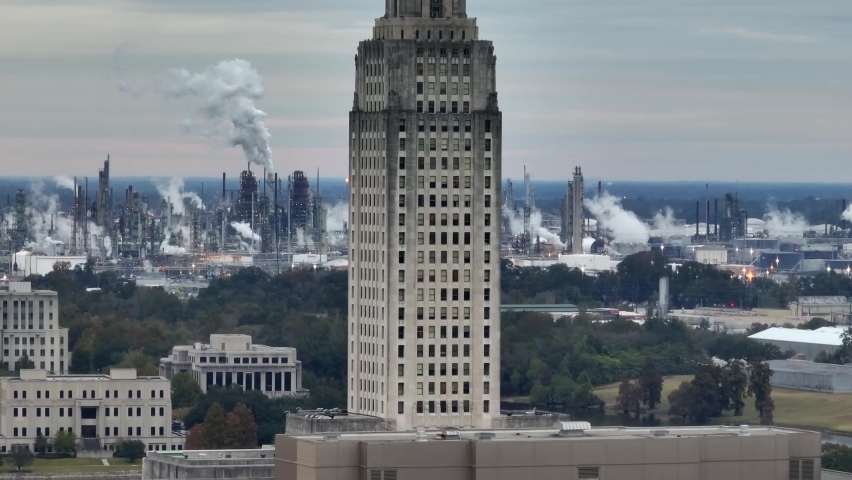 Louisiana state capital in Baton Rouge. Oil and gas petroleum industry refinery emissions in distance. Aerial view.