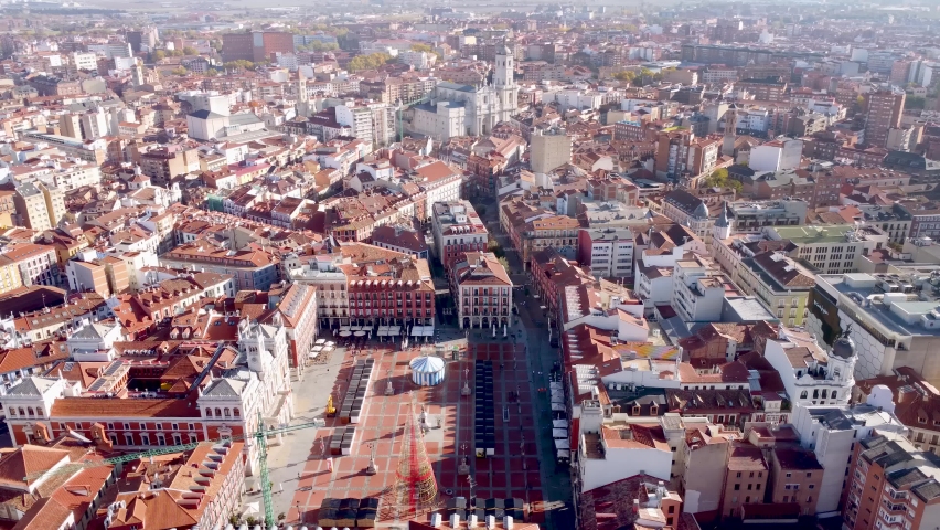 Aerial perspective of Valladolid city - Spain. View of city center with Plaza Mayor. In background is the Cathedral of Valladolid. Drone rotating right. Beautiful panorama of the city. Foggy morning. Royalty-Free Stock Footage #1097569539