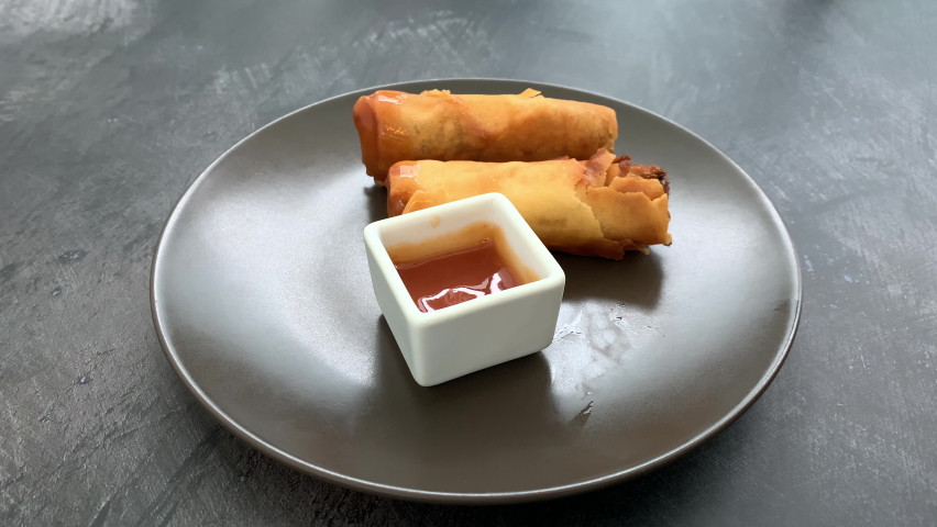 Dipping a Spring Roll into Sweet and Sour Sauce Royalty-Free Stock Footage #1097576861
