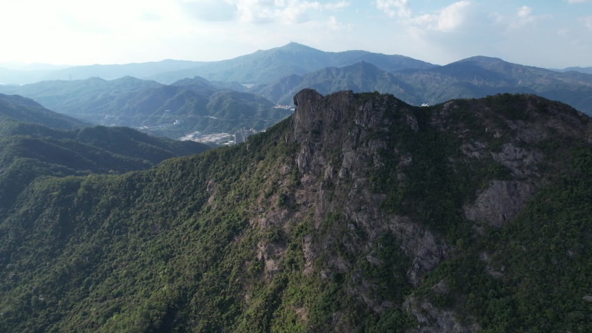 City skyview in Hong Kong 4K Aerial drone shot of the Lion Rock mountain traditional stone trails, characterized by rugged escarpments, it resembles a lion sitting regally near Kowloon Peninsula Royalty-Free Stock Footage #1097584687