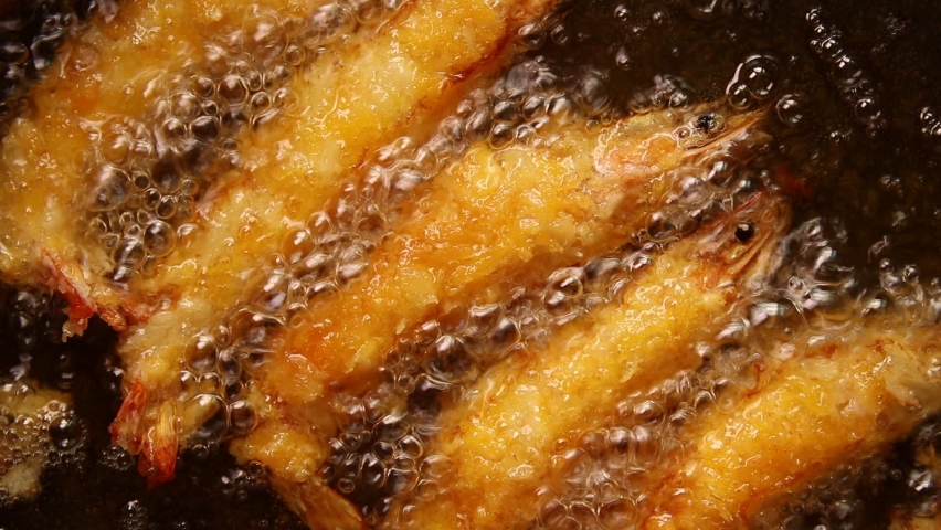deep-fried breaded shrimp in boiling oil. top view  Royalty-Free Stock Footage #1097586305