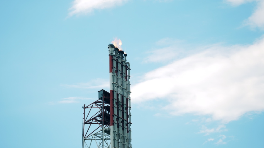 Pipes of an oil refinery plant with fire coming out of them