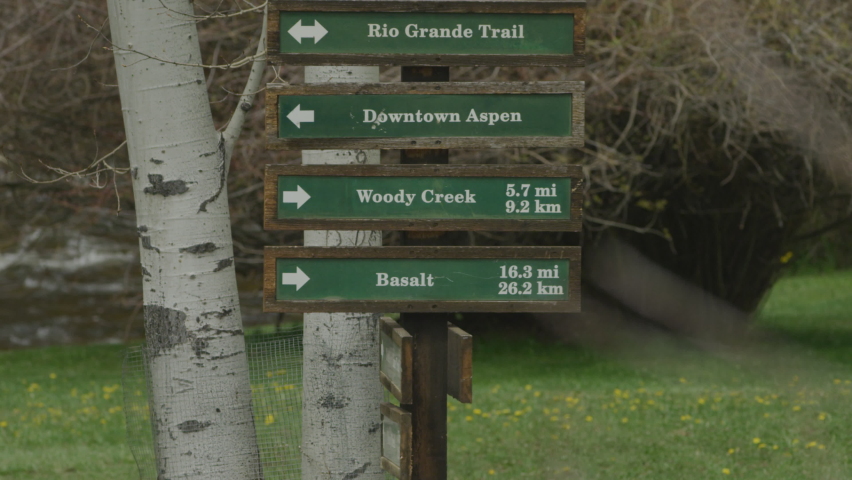 Directional signs for towns of mountain towns of Aspen, Basalt, and Woody Creek and the Rio Grande Trail in Colorado