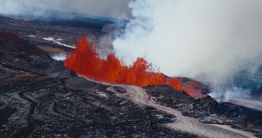 Aerial view of the Hawaii Mauna Loa volcano eruption of 2022, Hot lava and magma erupting out of the volcano into the sky, Shot on RED Royalty-Free Stock Footage #1097592219