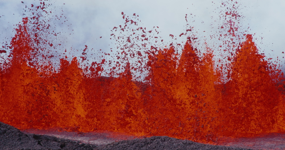 Slow motion of lava fountain shooting up into the air from the Hawaii Mauna Loa volcano eruption of 2022, Hot lava and magma erupting out of the volcano, Shot on RED Royalty-Free Stock Footage #1097592237