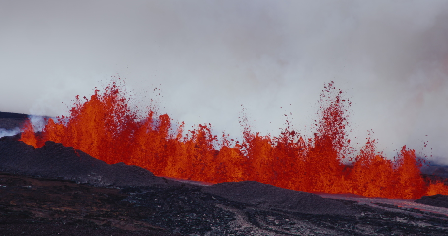 Aerial view of the Hawaii Mauna Loa volcano eruption of 2022, Hot lava and magma erupting out of the volcano into the sky, Shot on RED Royalty-Free Stock Footage #1097592245