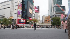 4K Blurred crowd of busy pedestrian people crossing city street crosswalk with road traffic at Shibuya, Tokyo City, Japan in autumn. Man and woman tourist shopping in the city while travel on vacation - Powered by Shutterstock - Get 15% off with code: PIKWIZARD15