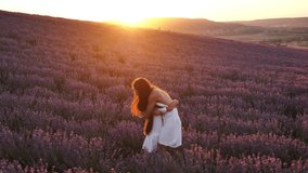 Mother and little daughter on a blooming lavender field at sunset. Slow motion. - Powered by Shutterstock - Get 15% off with code: PIKWIZARD15