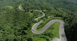 aerial view ROAD No.1081 beautiful curve winding mountain road between Pua District,Nan Province, Northern of Thailand is check-in point and landmark that tourist shooting photo,4k video aerial view,
