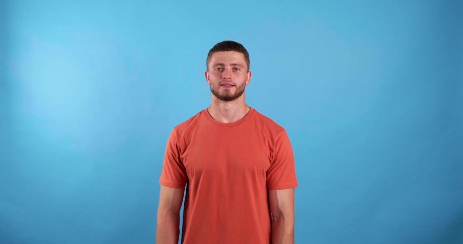 Young man showing thumbs up on light blue background | Shutterstock HD Video #1097599629