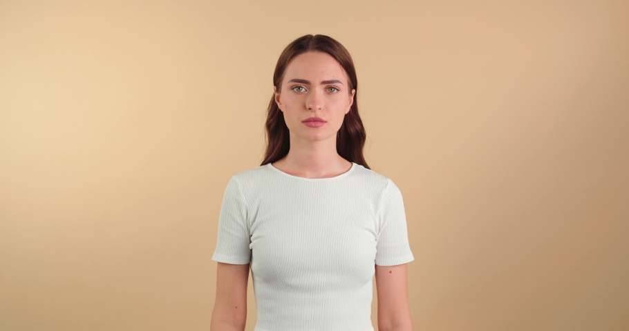 Indignant young woman resenting on beige background Royalty-Free Stock Footage #1097599681