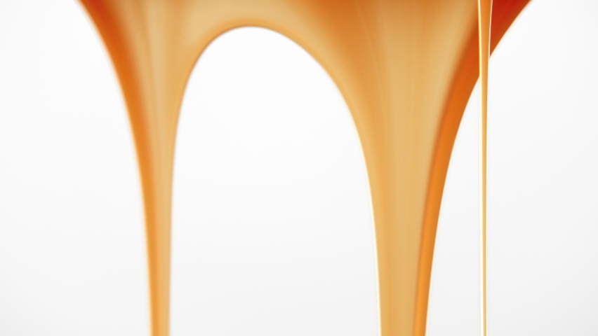Seamless dripping caramel droplets flowing down liquid sweet sauce on clean white background. Close-up macro shot flowing yellow orange tasty syrup drip. Confectionery, cooking dessert and candies