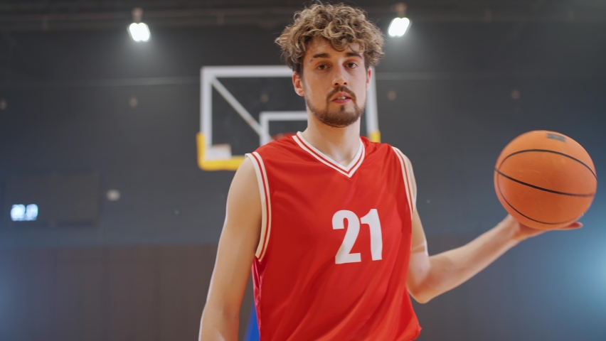 Basketball player hits the ball off the floor and warms up before the game, professional basketball player in a playground. - Powered by Shutterstock - Get 15% off with code: PIKWIZARD15