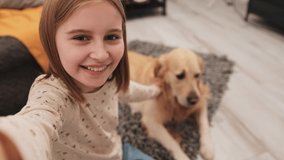 Preteen girl with golden retriever dog recording vlog content for social media followers. Pretty teen child with doggy pet making online streaming blog video