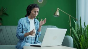 Stressed annoyed busy young businesswoman support manager with wireless headset looking at computer screen talking by online meeting conference video call using webcam at home workplace indoors  - Powered by Shutterstock - Get 15% off with code: PIKWIZARD15