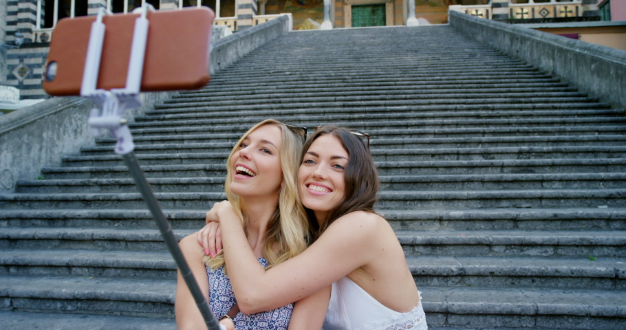 Phone selfie of travel friends at building, concrete stairs or Amalfi Cathedral Church for sightseeing adventure of Italy architecture. City tourist, selfie stick and happy people with memory picture | Shutterstock HD Video #1097610021