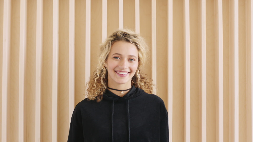 Happy, smile and fashion woman portrait against wall with cool, trendy and happy attitude. Young girl, student and gen z youth teenager standing outdoor with happiness, smiling and positive mindset