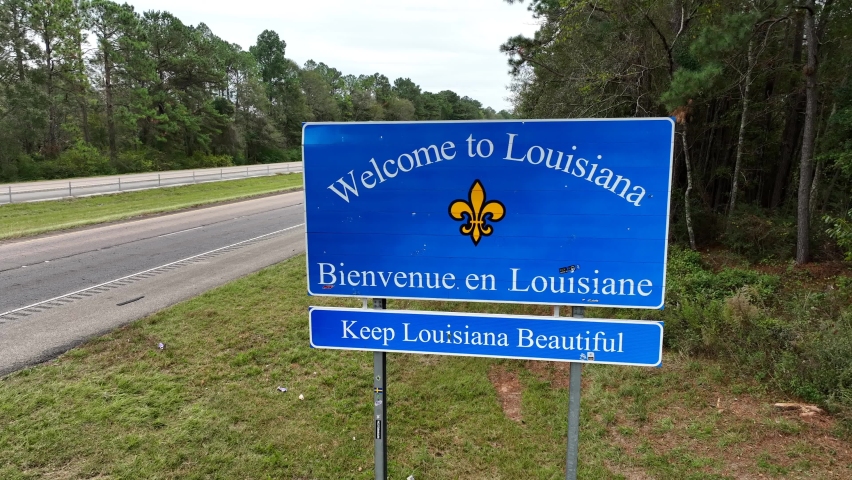 State Border , Louisiana , United States - 11 22 2022: Welcome to Louisiana. State sign along interstate highway border with Mississippi. USA state in deep south. Aerial view.