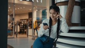 Female student middle-eastern girl businesswoman arabian ethnic woman student shopper chatting on phone sit at shopping center use mobile apps purchasing online read digital news watch internet video - Powered by Shutterstock - Get 15% off with code: PIKWIZARD15