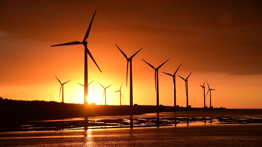 Sunset view of the Gaomei wetlands landscape and the wind power plant in Taichung, Taiwan. energy systems and renewable energy.