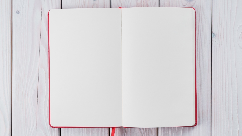 Red diary book with white empty papers, turning endless from right to left on white wooden background. Start living from scratch, new beginnings. Stop motion, looped video, copy space and template Royalty-Free Stock Footage #1097618149
